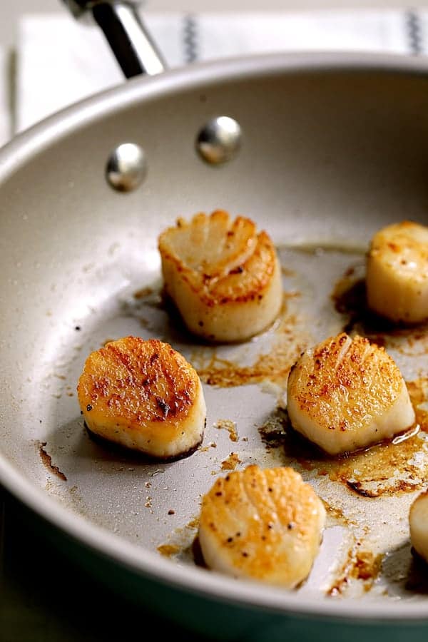 Photo of seared scallops in skillet.