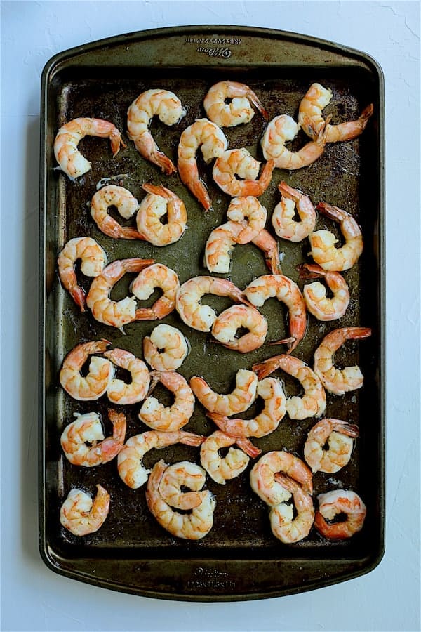 Photo of roasted shrimp on baking sheet.