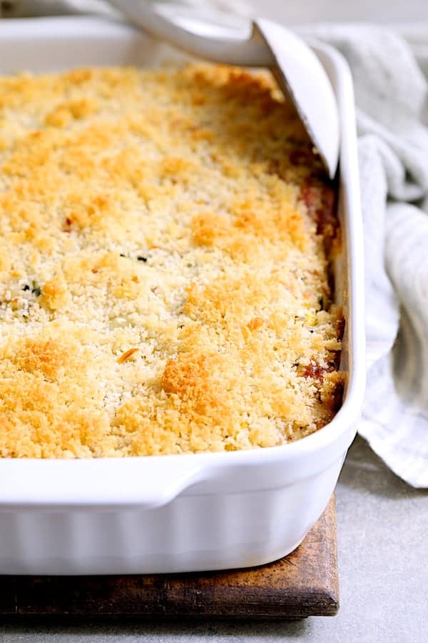 Photo of Zucchini, Yellow Squash and Quinoa Casserole in white baking dish before being served.