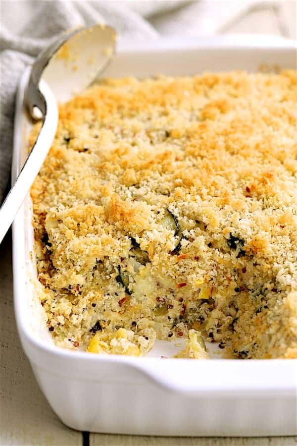 Close-up photo of Zucchini, Yellow Squash and Quinoa Casserole with some served to show interior.