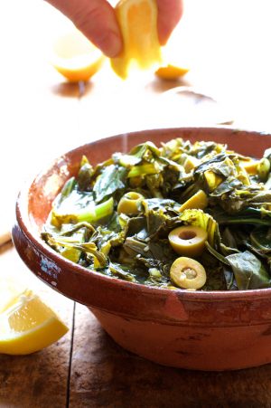 Braised Greens with Olives and Lemon in stoneware bowl.