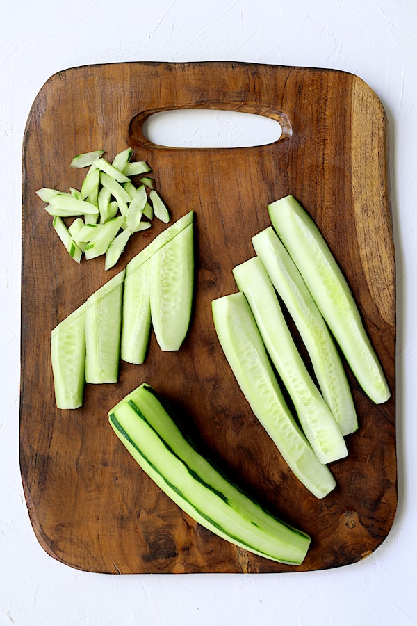 Photo showing the four steps to a decorative way to cut a cucumber.
