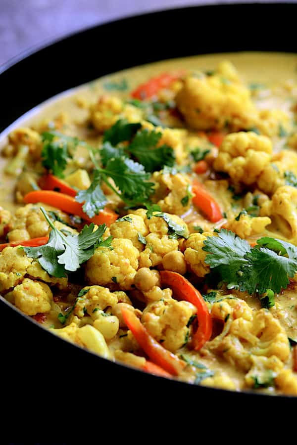 Close-up photo of Vegan Indian Cauliflower and Chickpea Curry garnished with cilantro.