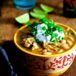 One serving of Chicken, Chipotle and White Bean Chili in yellow and red bowl.