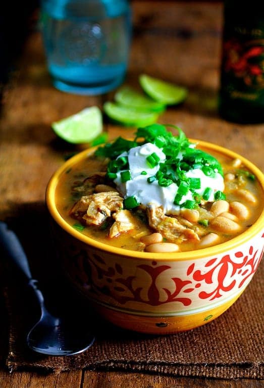 One serving of Chicken, Chipotle and White Bean Chili in yellow and red bowl.