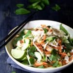 Vietnamese Chicken Salad in white bowl with black chopsticks.