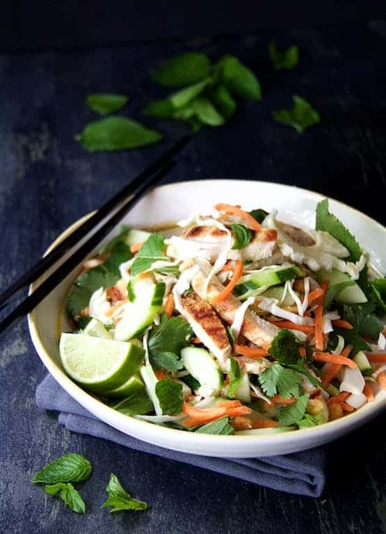 Vietnamese Chicken Salad in white bowl with black chopsticks.