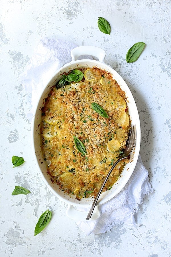 Photo of Yellow Squash and Tomato Gratin with Two Cheeses after being baked with serving fork.