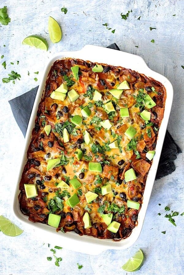 Black Bean and Yellow Squash Enchilada Casserole with serving spoon before being cut.