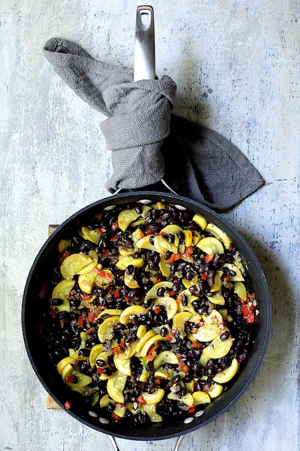 Photo of sauteed yellow squash with black beans added.