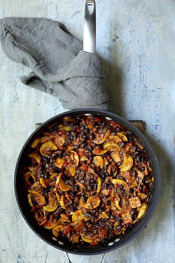 Photo of ingredients for Black Bean and Yellow Squash Enchilada Casserole combined in skillet.