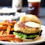 Shrimp Burgers with Jalapeno Remoulade and sweet potato fries on white plate.