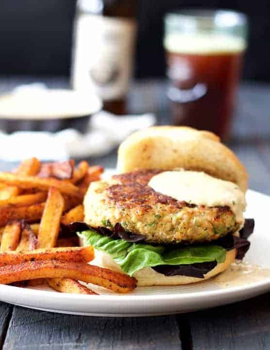 Shrimp Burgers with Jalapeno Remoulade and sweet potato fries on white plate.