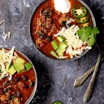 Two servings of Turkey, Black Bean and Quinoa Chili in gray speckled bowls.