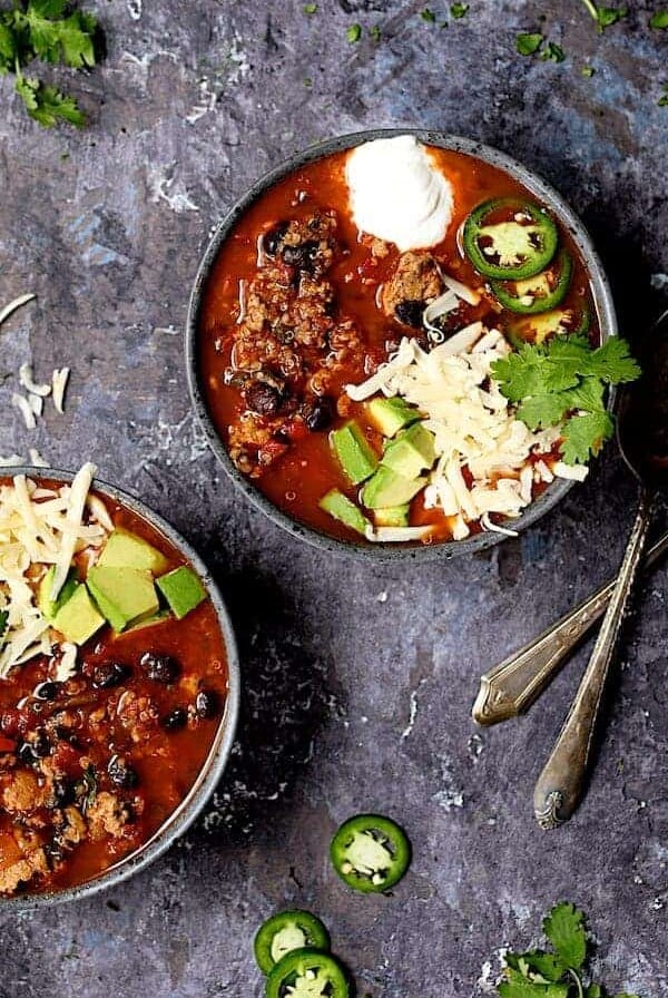 Two servings of Turkey, Black Bean and Quinoa Chili in gray speckled bowls.