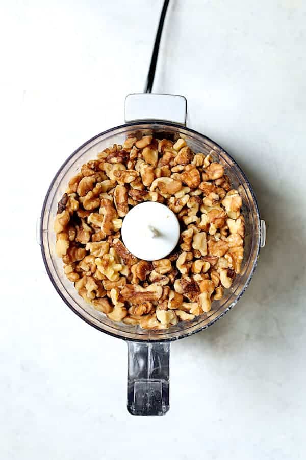 Overhead shot of walnut pieces in mini food processor