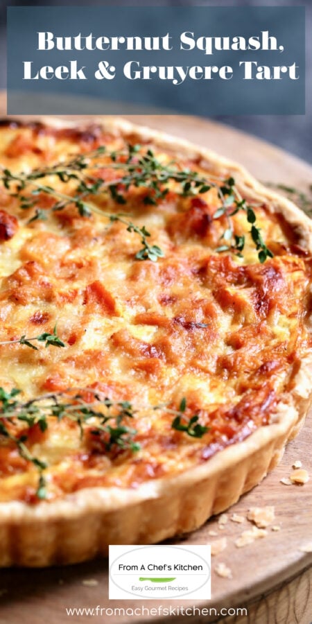 Pinterest graphic for Butternut Squash, Leek and Gruyere Tart showing it whole on a wooden cakestand .
