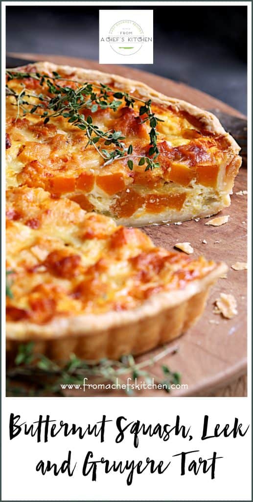 Pinterest graphic for Butternut Squash, Leek and Gruyere Tart on wood cutting board with slice removed.