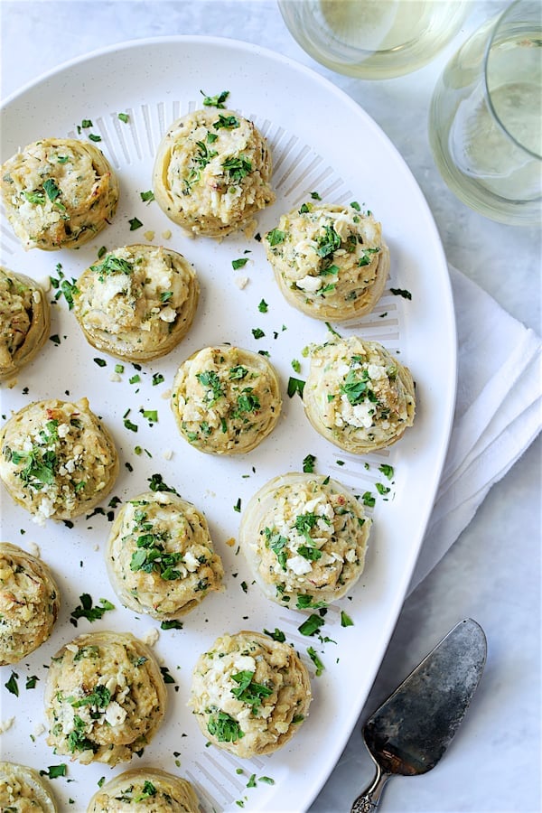 Photo of Deviled Crab Stuffed Artichoke Bottoms on white platter.