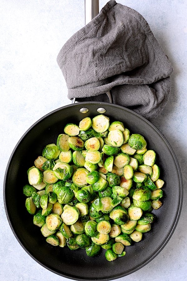 Photo of slightly charred Brussels sprouts in nonstick skillet.