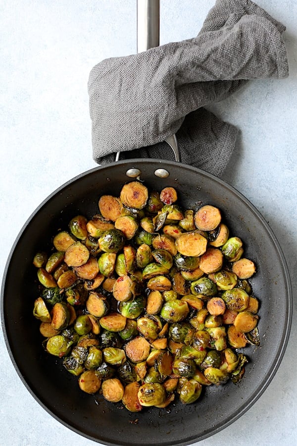 Photo of glazed Brussels sprouts in nonstick skillet.