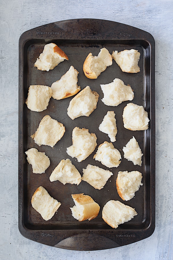 Overhead shot of unbaked croutons on baking sheet