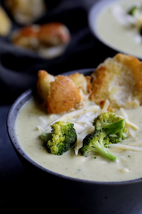 Broccoli Gruyere Soup with Torn Garlic Croutons - Close-up shot of soup in gray bowl