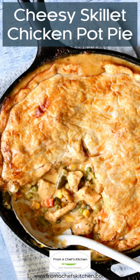 Pinterest graphic for Cheesy Skillet Chicken Pot Pie showing it with a piece removed in black cast iron skillet.