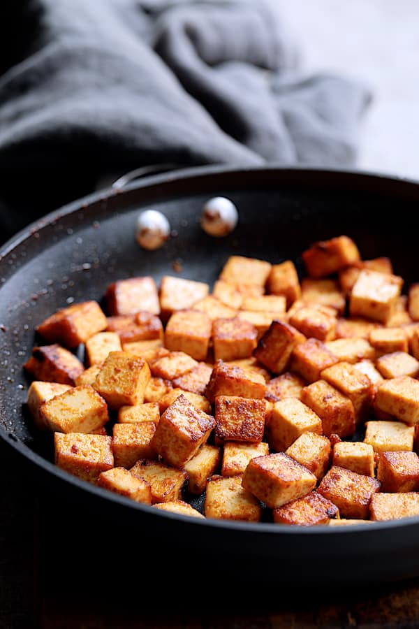 Photo of tofu being browned in nonstick skillet