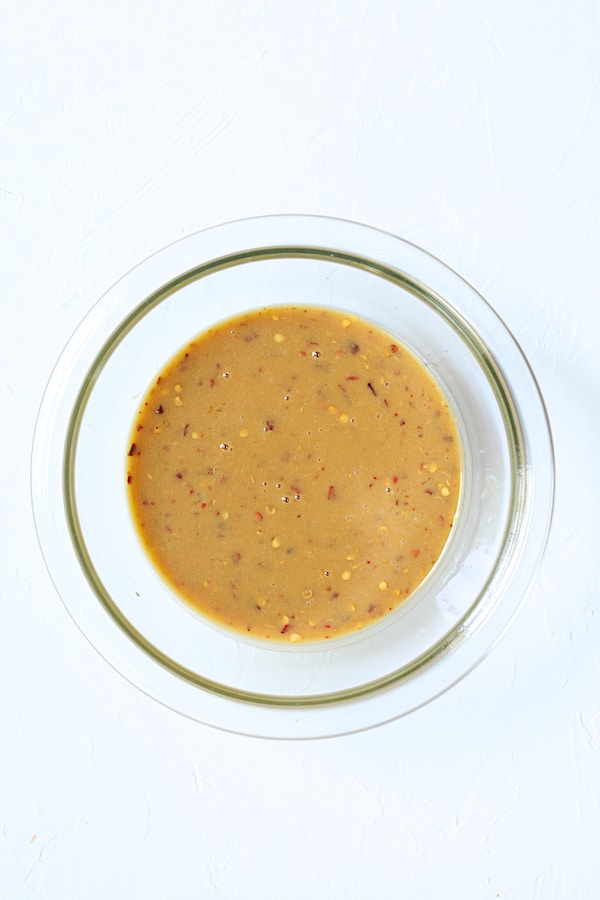 Overhead shot of sauce ingredients in glass bowl