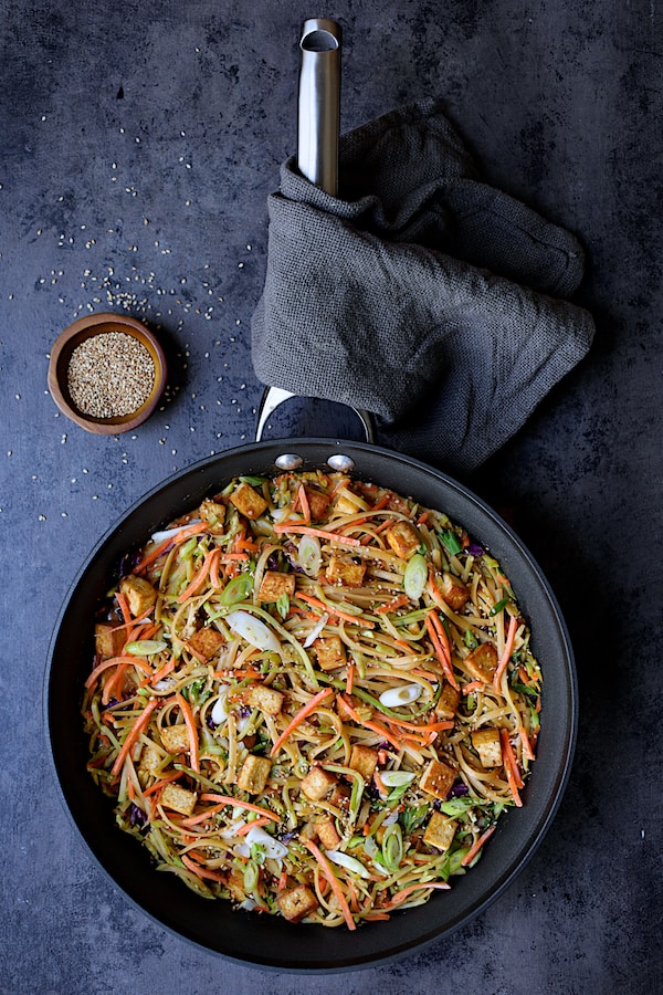 Thai Sesame Noodles with Tofu and Vegetables - Overhead shot of noodles in skillet garnished with sesame seeds