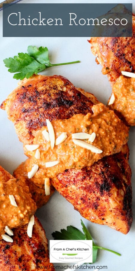 Pinterest graphic for Chicken with Romesco showing it on a gray-rimmed platter garnished with fresh parsley.