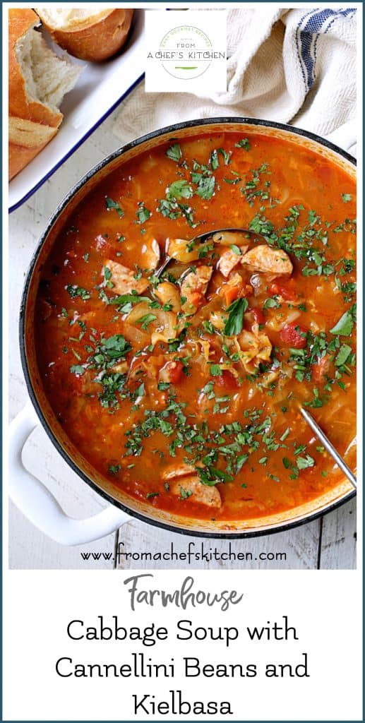 Pinterest graphic for Farmhouse Cabbage Soup with Cannellini Beans and Kielbasa showing it in a white Dutch oven.