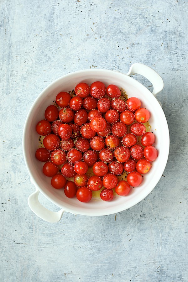 Photo of tomatoes in white baking dish before baking.