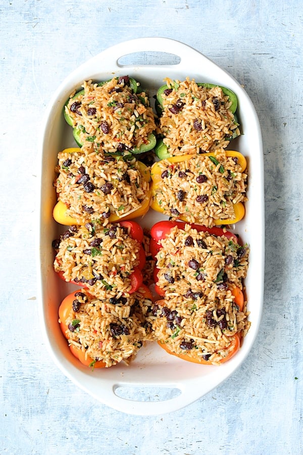 Photos of peppers stuffed with rice, bean and chicken combination in white baking dish.