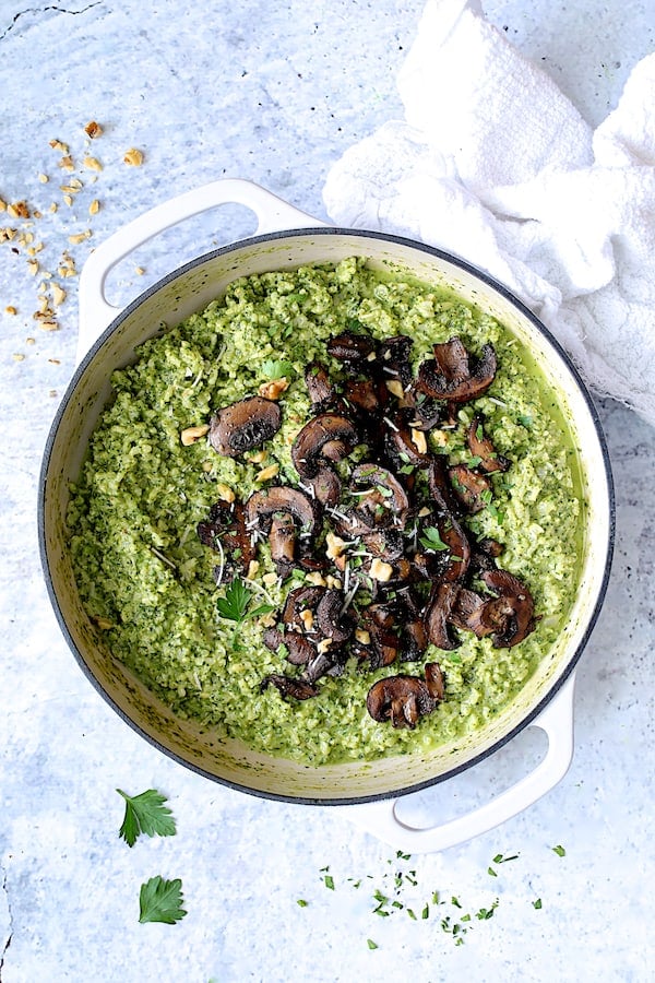 Photo of Oven Risotto with Kale Pesto and Roasted Mushrooms in white skillet.