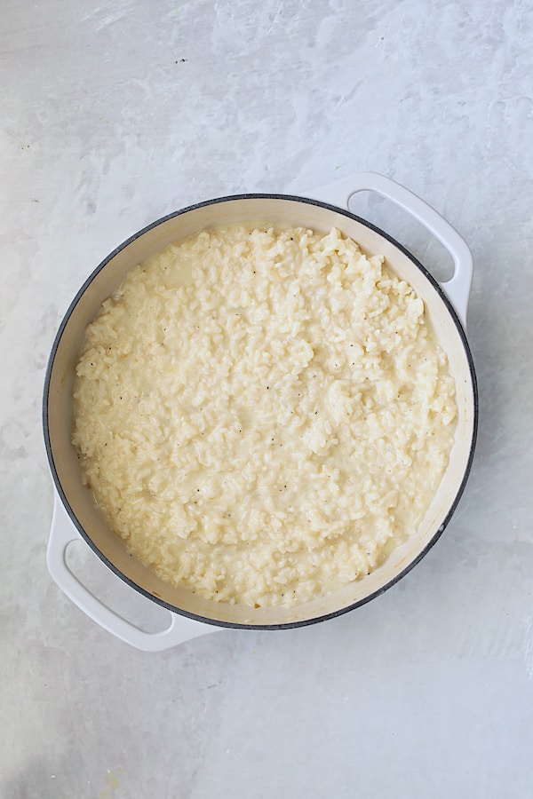 Photo of finished risotto in white cast iron pan before adding pesto.