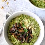 One serving of Oven Risotto with Kale Pesto and Roasted Mushrooms in white dinner bowl.
