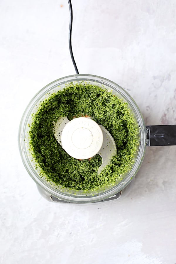 Photo of kale pesto in food processor.