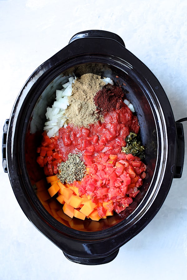 Overhead shot of more of the ingredients being added to the slow cooker