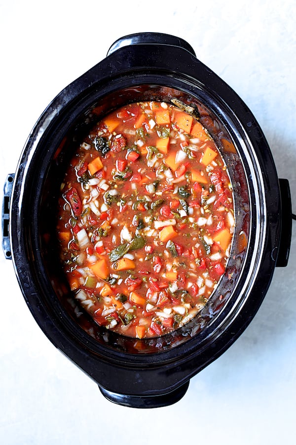 Overhead shot of ingredients for stew mixed together in slow cooker