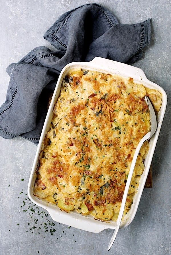 Country-Style Potato and Cabbage Casserole with Cheddar and Bacon in white rectangular baking dish.