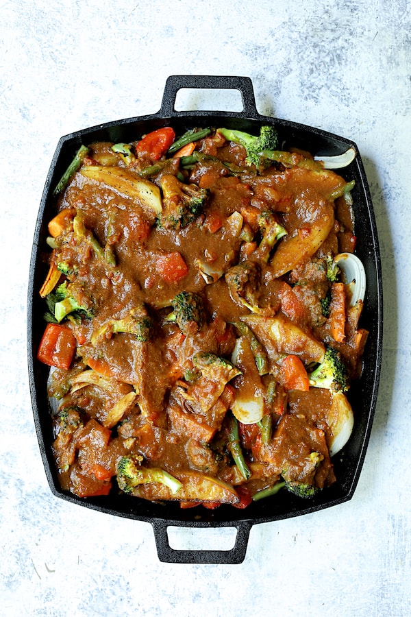 Photo of finished roasted vegetables with sauce added.