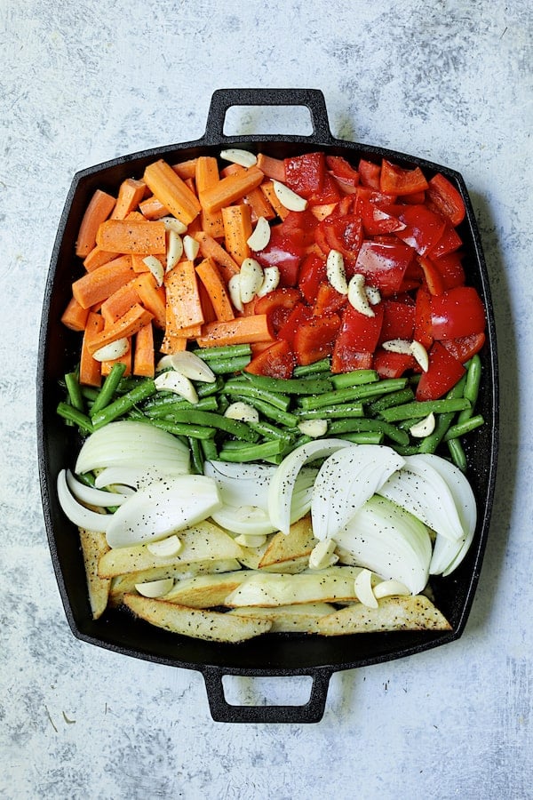 Photo of vegetables on cast iron pan ready for roasting.