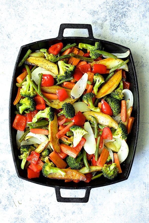 Photos of roasted vegetables on cast iron pan.