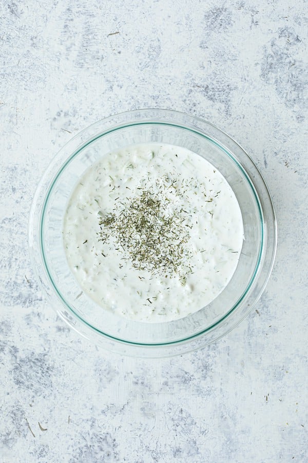 Photo of tzatziki sauce in glass bowl.