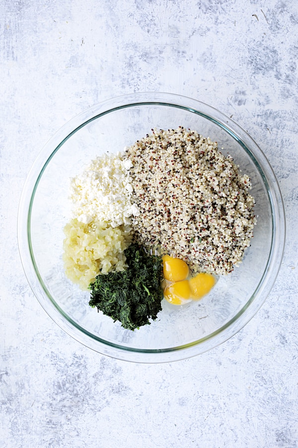 Photo of quinoa cake ingredients in glass bowl.