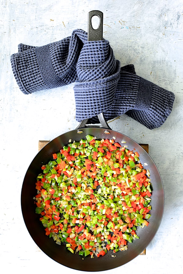 Photo of cooked peppers and onions in skillet.
