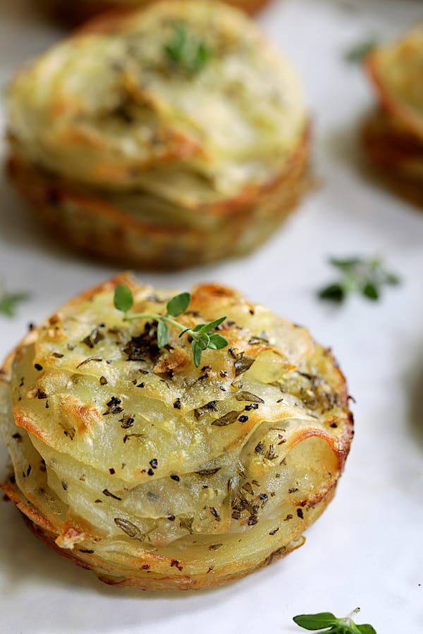 Close-up photo of one of the Garlic Herb Muffin Pan Potato Galettes garnished with fresh thyme.