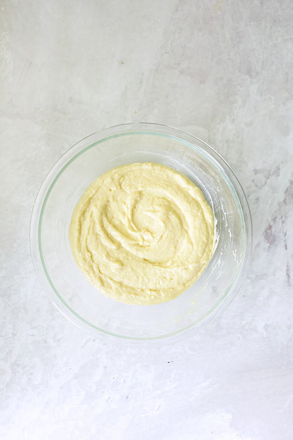 Photo of wet and dry ingredients combined in glass bowl.